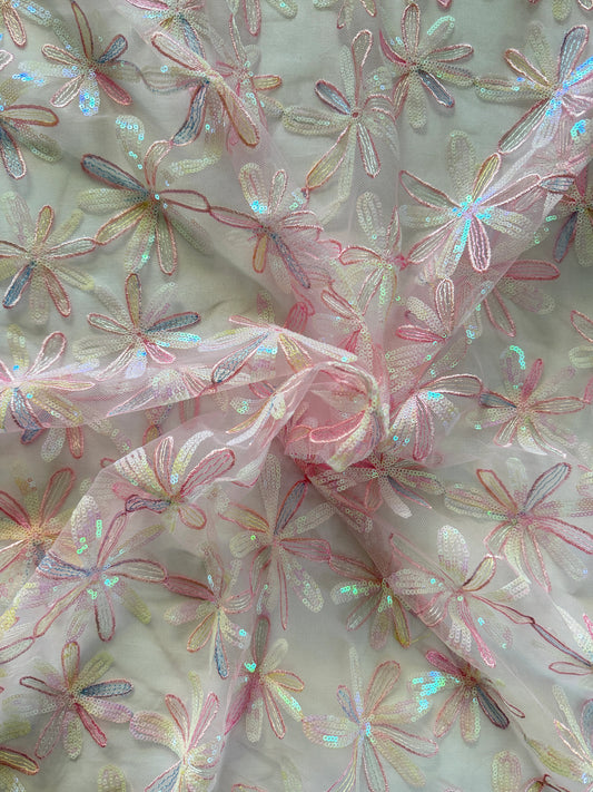 Close up of daisy flower sequin embroidery on Luma pink Sudanese toub