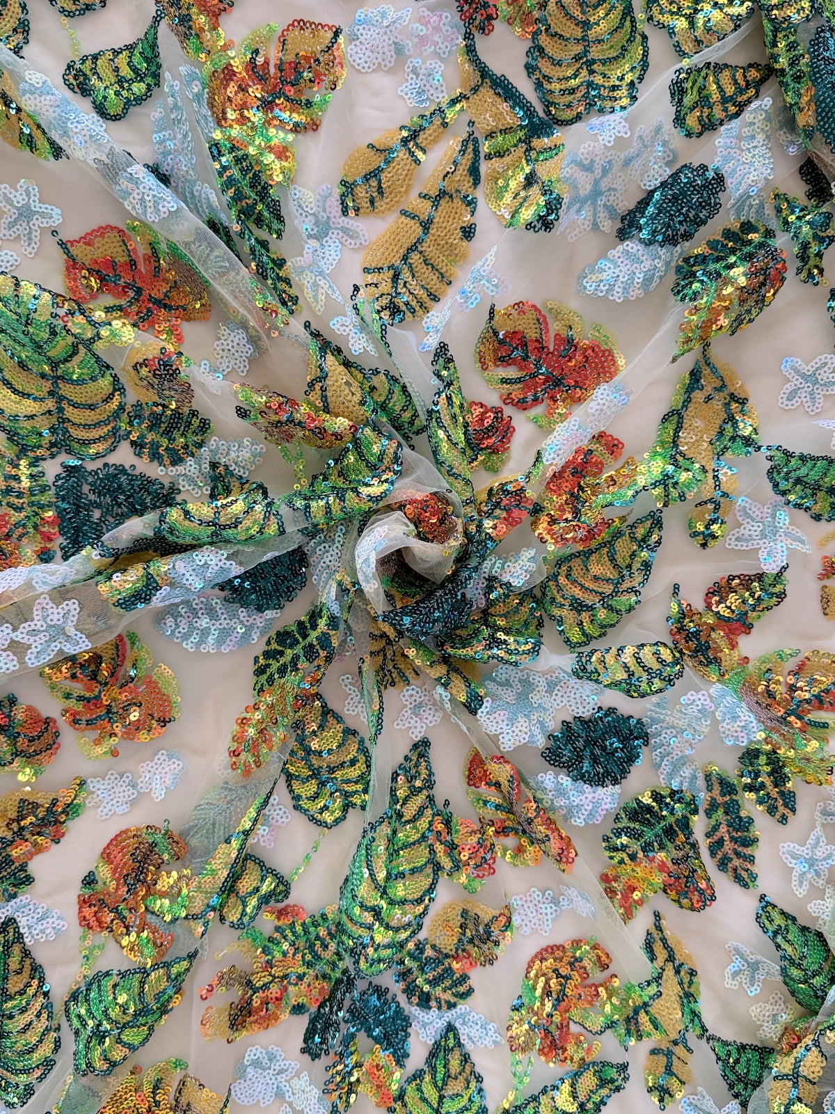 Close-up of green gold orange teal sequin work on Nadrah sudanese toub