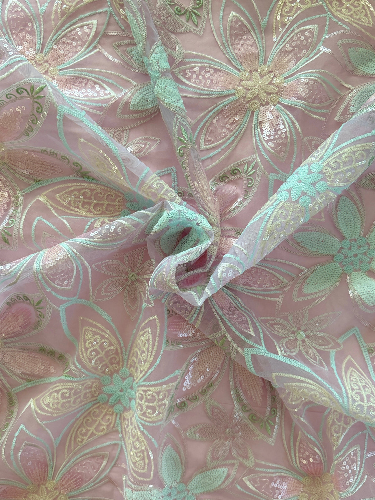 close up of Full floral sequin in pink mint and gold on Rawda dusty blush Sudanese toub by Asalah