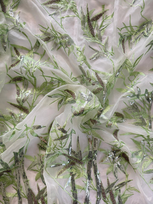 Close up of green leaf embroidery on Rimah Sudanese toub