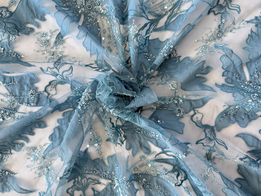 Close up of tonal blue floral embroidery and sequin beading on Zahrah Sudanese toub