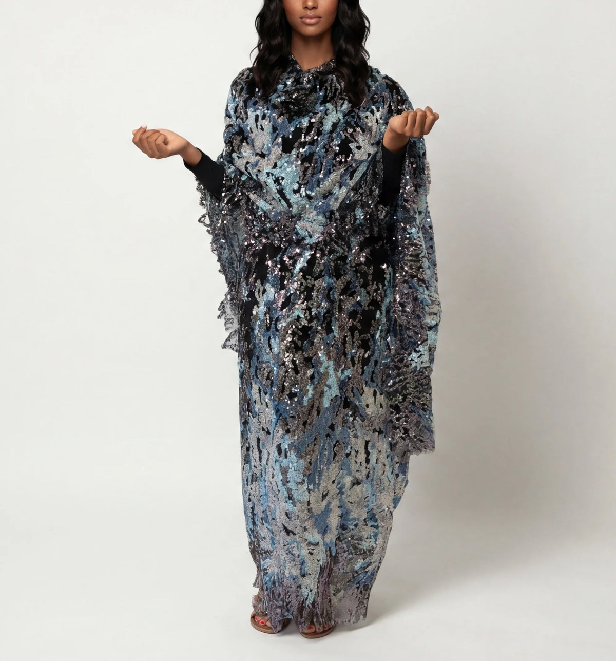Layl - black Sudanese toub with blue and silver sequin embroidery, front view worn draped