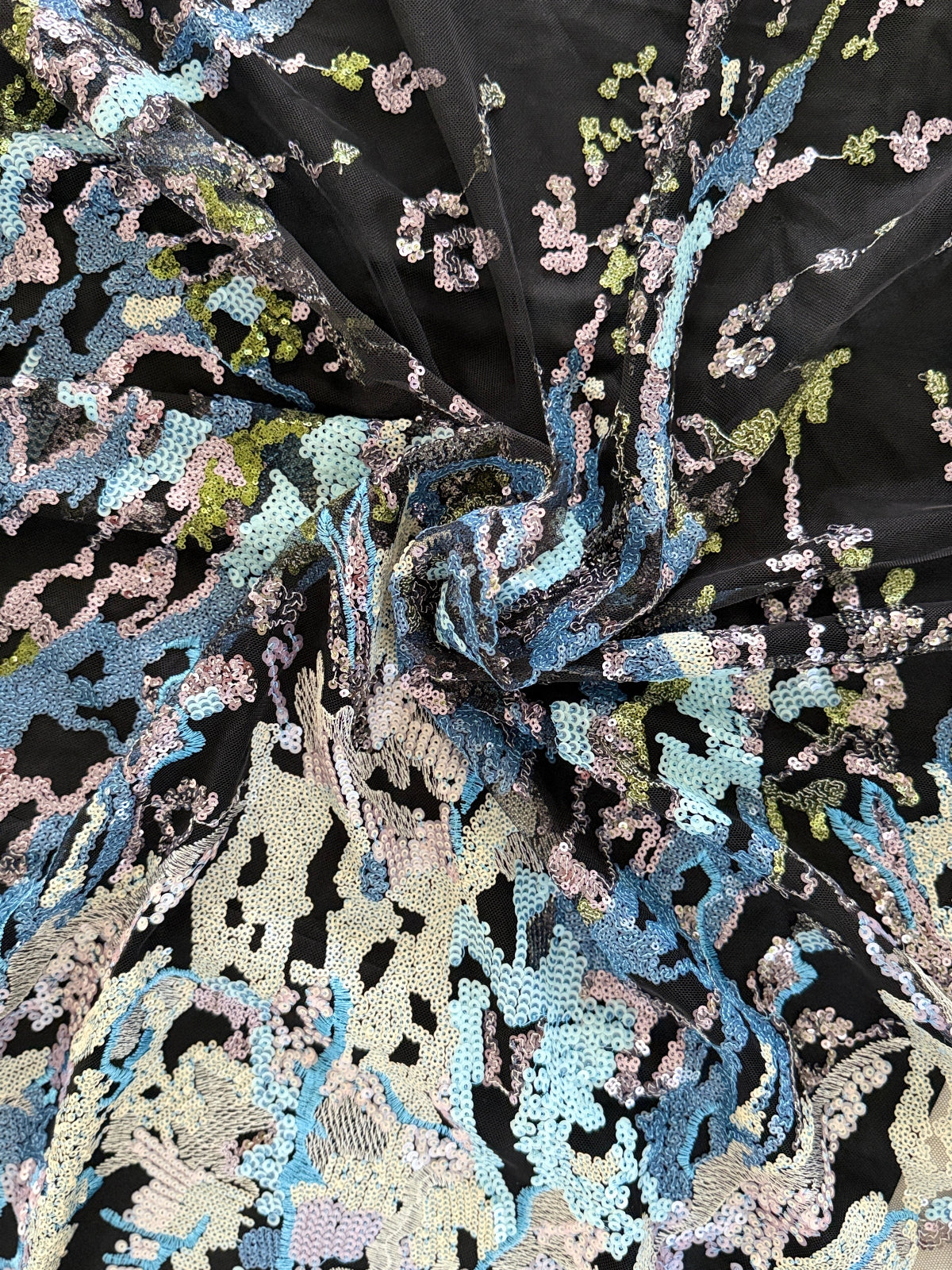 Close up of blue and silver sequin embroidery on tulle Layl Sudanese toub