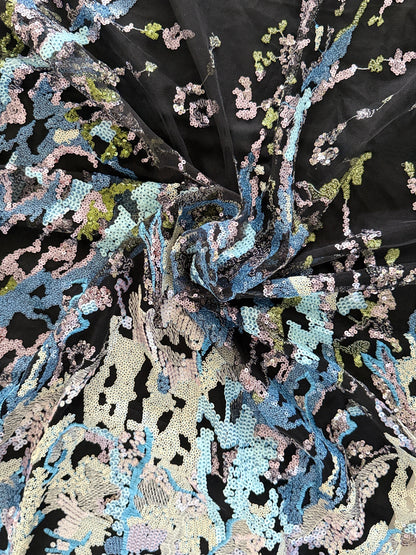 Close up of blue and silver sequin embroidery on tulle Layl Sudanese toub