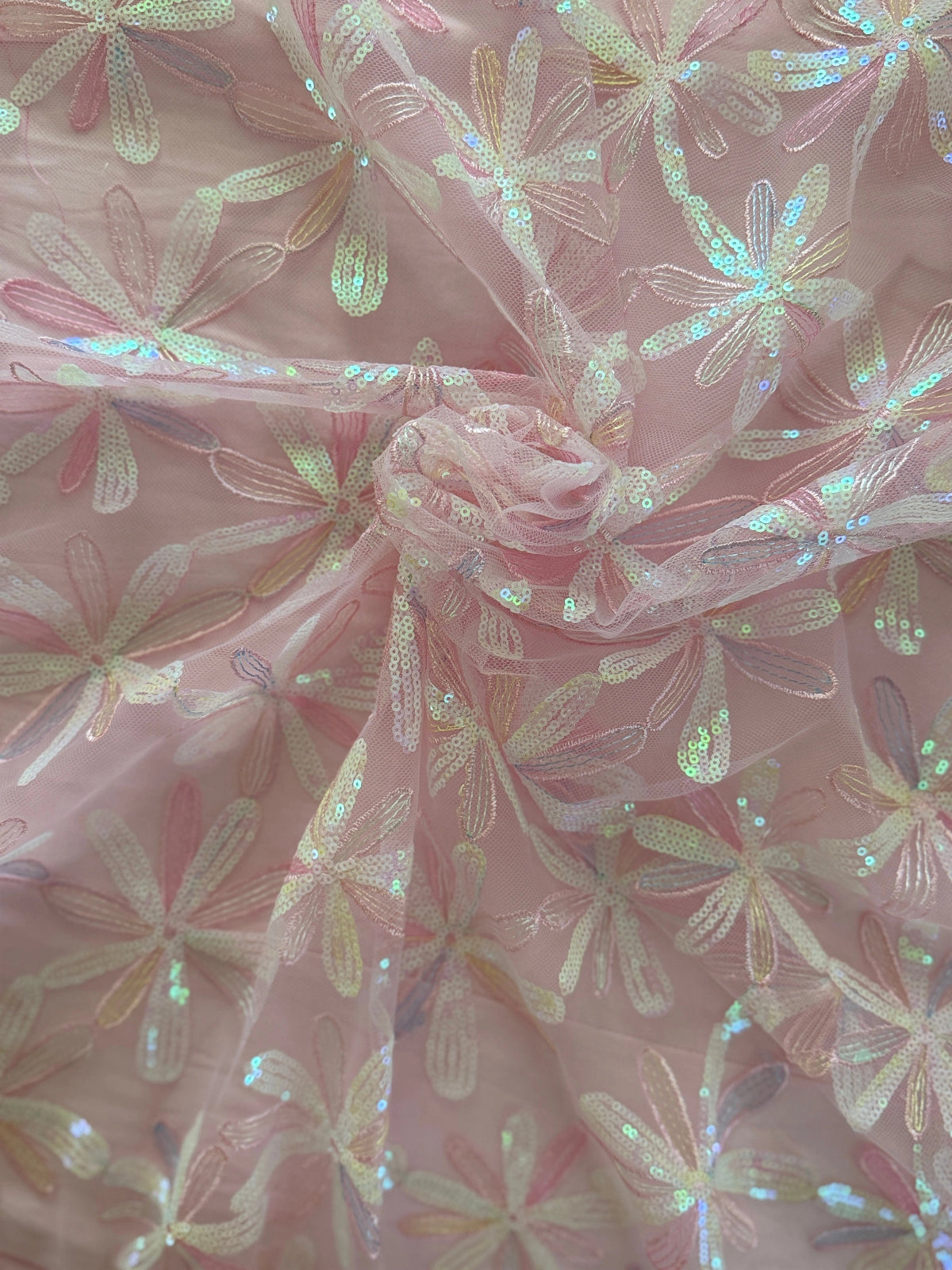 Close up of pink daisy flower sequin embroidery on Luma Sudanese toub
