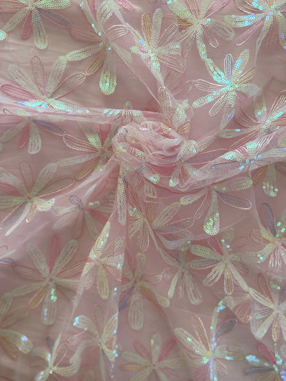 Close up of pink daisy flower sequin embroidery on Luma Sudanese toub