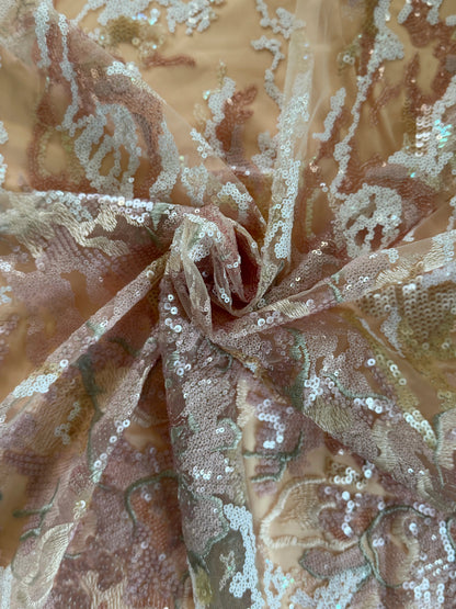 Close up of sheer fabric with floral patterns and sequins on a beige background on Nahla Sudanese toub