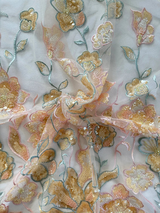 Close up of peach and gold floral sequin embroidery on Ruwa Sudanese toub