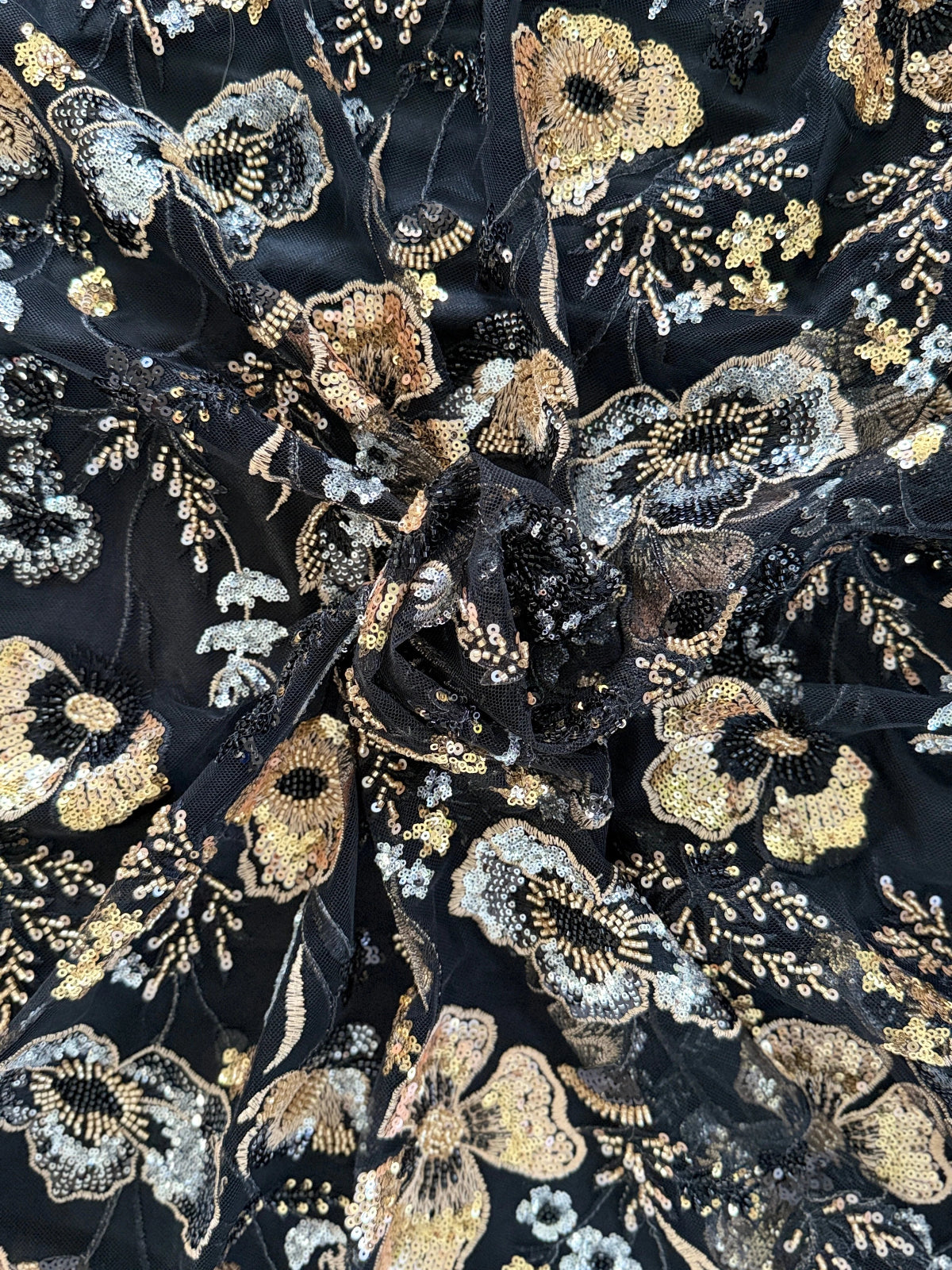 Close up of gold and silver floral sequin on Samar Sudanese toub