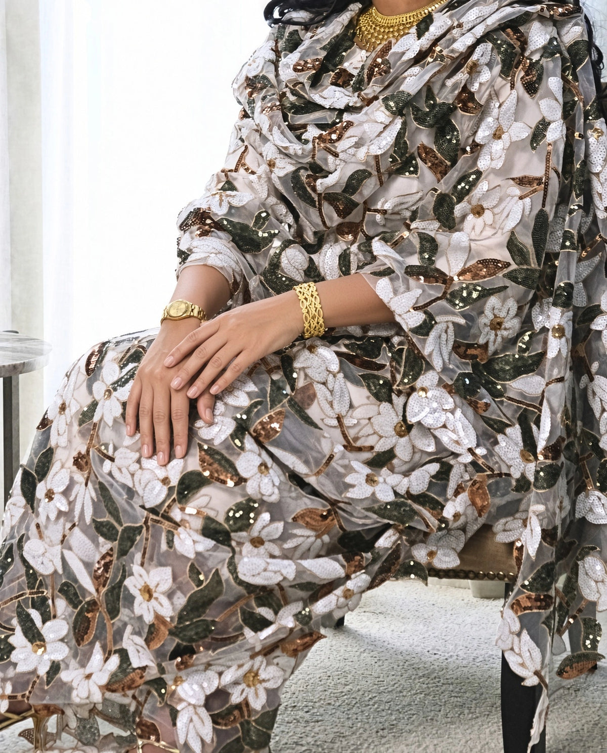 Ward Toub - White Sudanese toub with white floral and green leaf embroidery, seated view