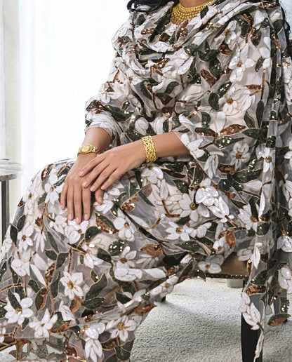 Ward Toub - White Sudanese toub with white floral and green leaf embroidery, seated view