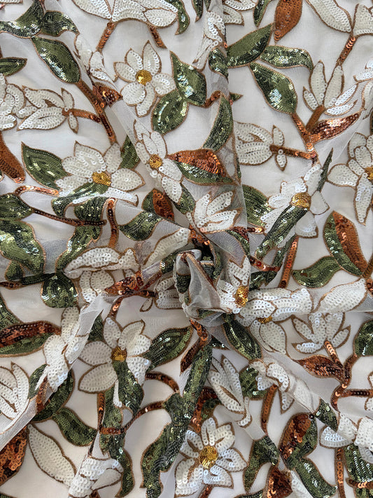 Close up of white floral and green sequin embroidery on Ward Sudanese toub