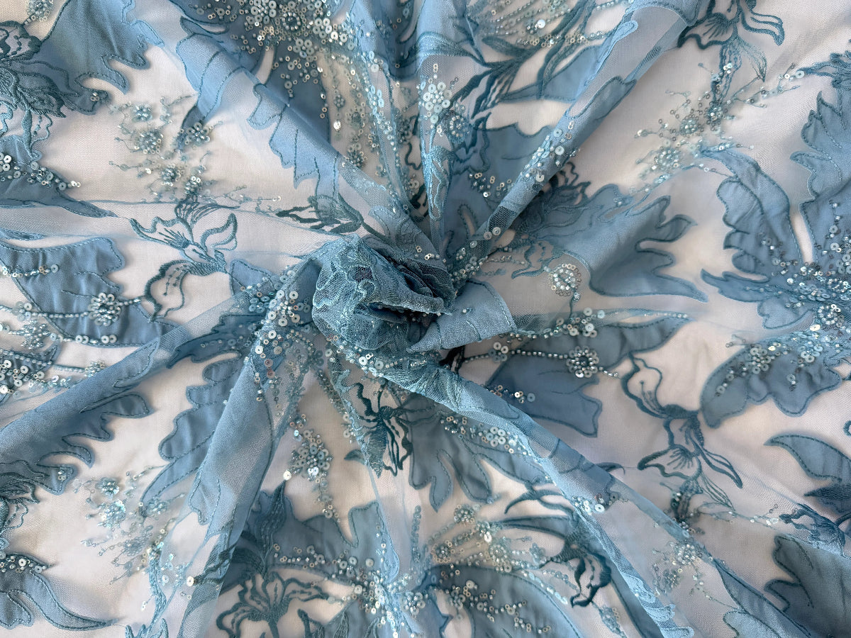 Close up of tonal blue floral embroidery and sequin beading on Zahrah Sudanese toub