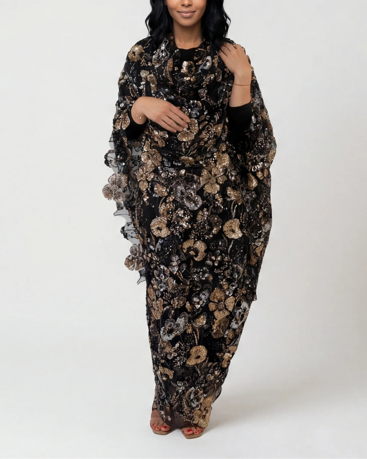 Samar black Sudanese toub with gold floral sequin embroidery, front view worn draped